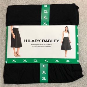 Midi length black skirt.